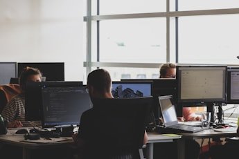 Security analysts reviewing threat activity on workstation monitors
