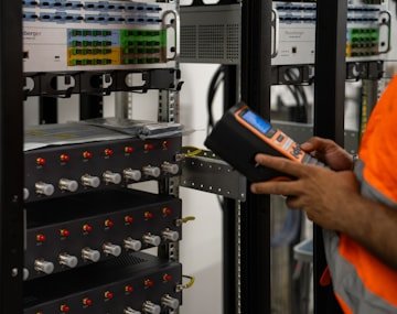 Engineer running diagnostics on server racks during a security audit